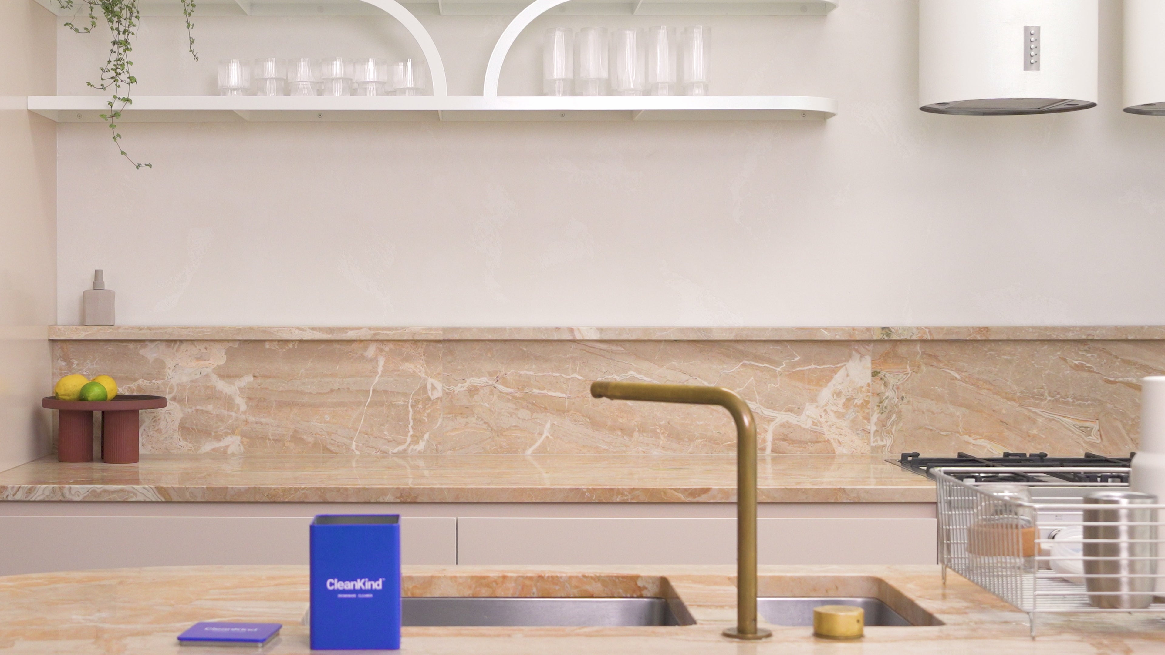 Load video: A woman showing step by step of how to wash her drink bottle using CleanKind non-toxic natural powder drinkware cleaner in the kitchen.